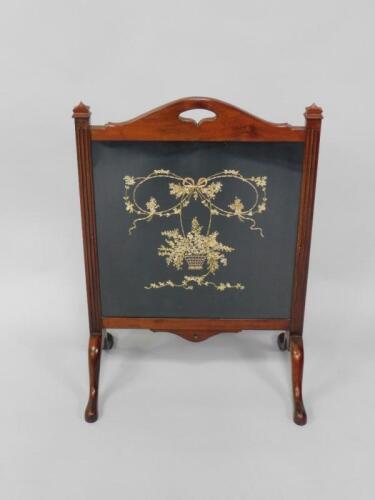 An Edwardian mahogany fire screen