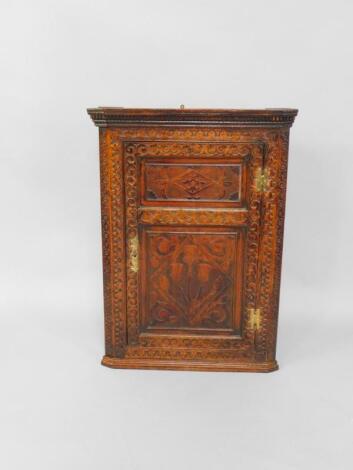 A 19thC oak hanging corner cupboard