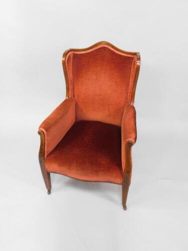 An Edwardian mahogany and line inlaid wingback armchair