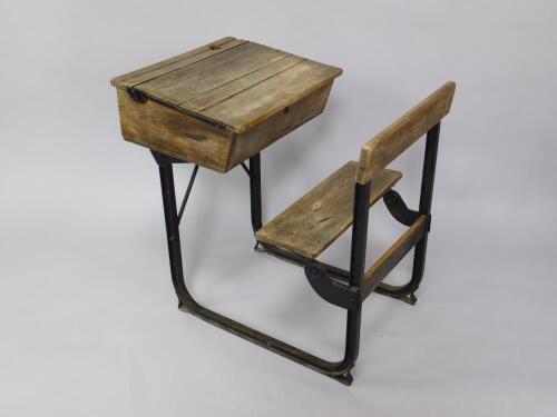 An early 20thC oak and iron framed child's school desk