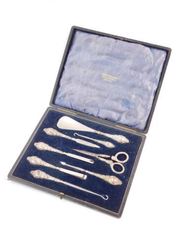 An Edwardian VII eight piece manicure set with silver handles