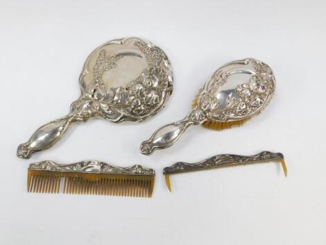 A George V silver backed three piece dressing table set