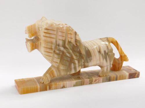 A vari-coloured onyx marble model of a lion