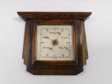 An Art Deco oak cased aneroid wall barometer