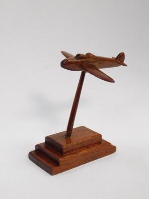 A 20thC carved hardwood figure of a WWII fighter plane