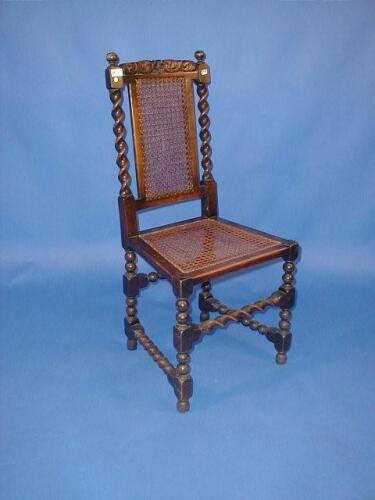 A set of four barley twist oak dining chairs with cane backs and seats