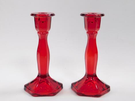 A pair of early 20thC ruby glass candlesticks