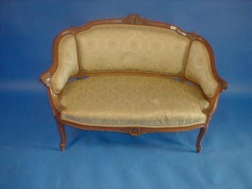 A Victorian carved walnut two seater sofa with carved and shaped walnut