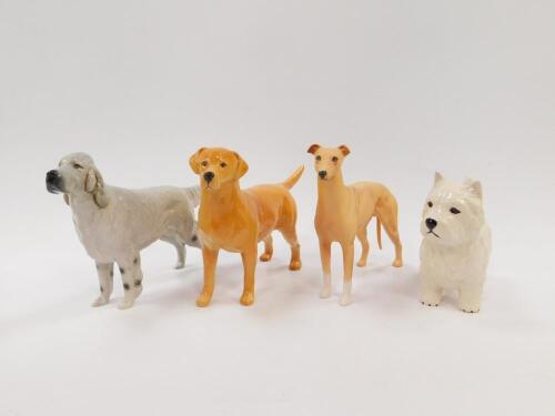 Four Beswick pottery dogs