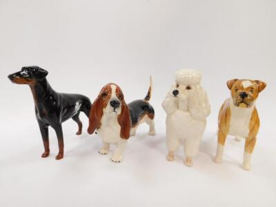 Four Beswick pottery dogs