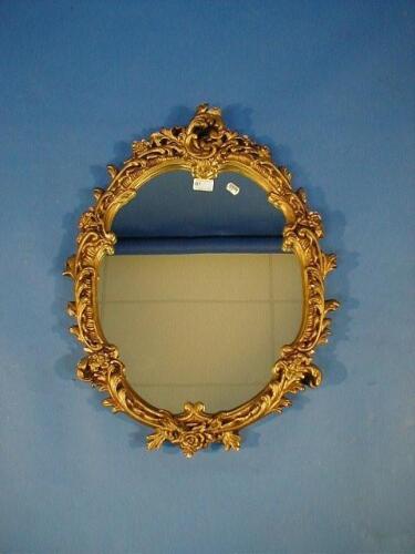 A rococo gilt plaster framed wall mirror