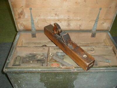 A painted pine carpenter's tool chest fitted with slides and containing chisel