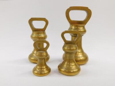 Four bell shaped brass weights