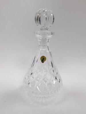 A Waterford cut glass decanter and stopper decorated in the Lismore pattern