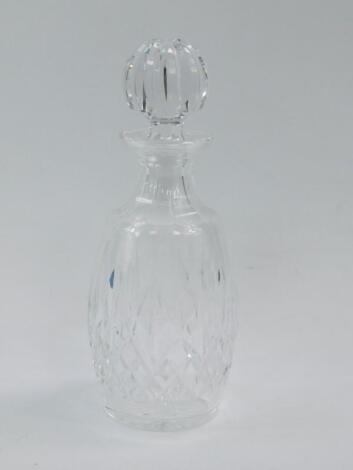 A Waterford cut glass decanter and stopper decorated in the Lismore pattern