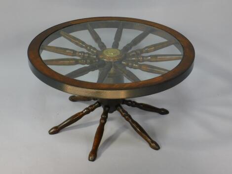 An oak circular cartwheel occasional table