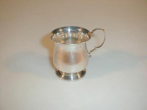 A silver baluster mug with a double scroll handle