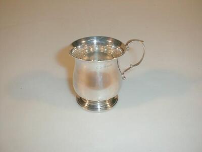 A silver baluster mug with a double scroll handle