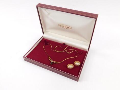 A 9ct gold necklace set with a sapphire teardrop and a single diamond