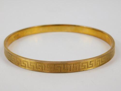 A bangle with engraved Greek Key decoration