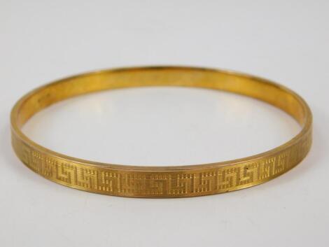 A bangle with engraved Greek Key decoration