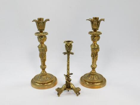 A pair of late 19thC loaded brass candlesticks