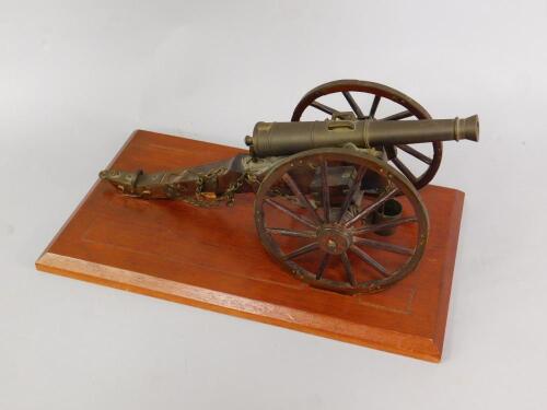 A wooden and brass scale model of a Napoleonic cannon