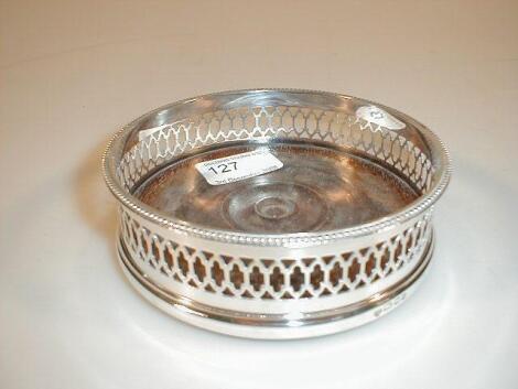 A modern silver wine coaster