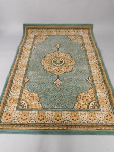 A Caucasian turquoise and brown fine wool rug