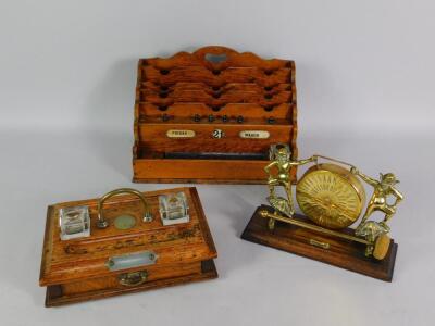 A Victorian oak stationery rack