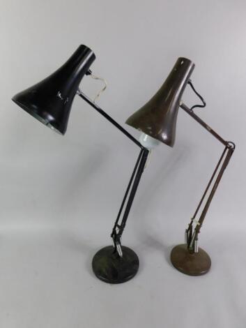 A black anglepoise type table lamp