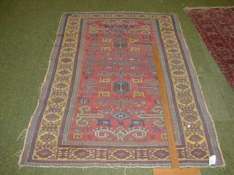 A Turkish design multi border rug with yellow banding and red ground central field