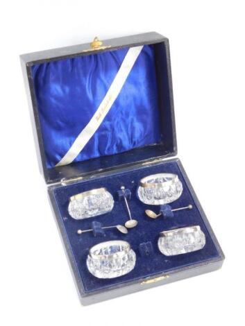 A set of four George V cut glass salts with silver rims