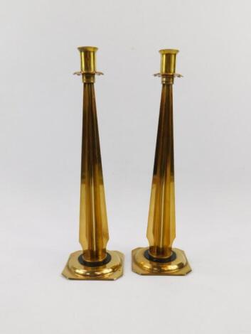 A pair of mid 20thC industrial brass candlesticks