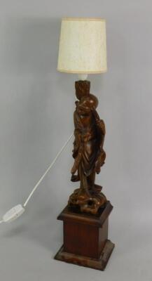 A Chinese carved hardwood figure of a peasant holding a bat