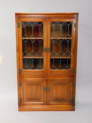 An Old Charm oak cupboard bookcase