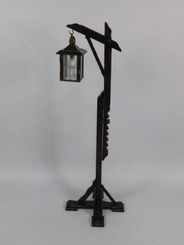 An oak lantern formed standard lamp