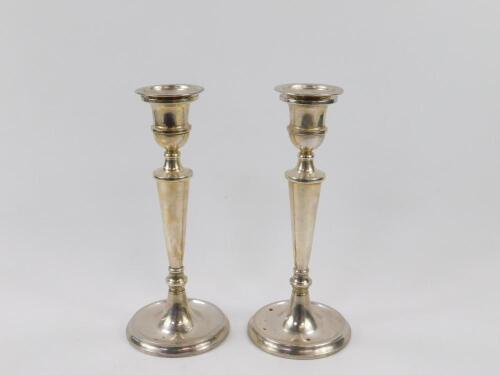 A pair of loaded baluster turned silver candlesticks