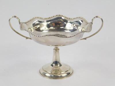 A George V silver twin handled pedestal sweetmeat dish