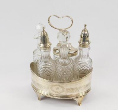 A George III silver and cut glass five bottle cruet on stand