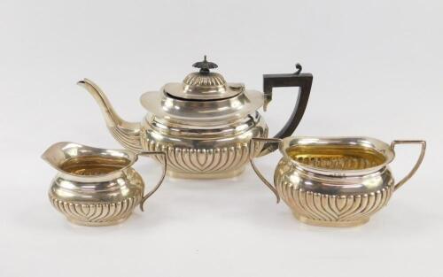 A George VI silver semi fluted three piece tea set