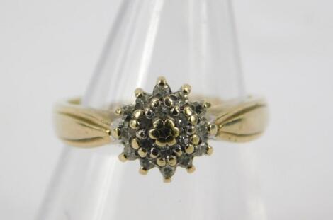 A 9ct gold and diamond flower head ring