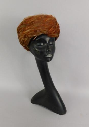 A black stylised female mannequin bust