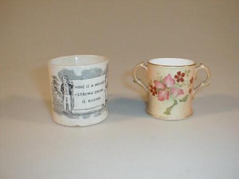 An early 19thC pottery mug painted in black with two figures holding a