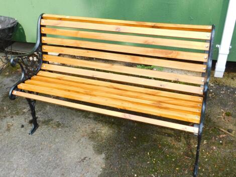 A wooden bench with black iron ends