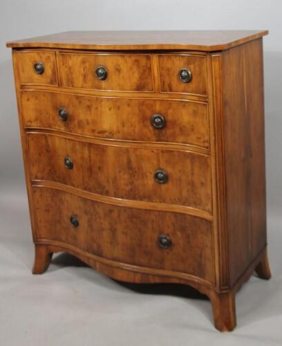 A 20thC yew wood finish serpentine chest