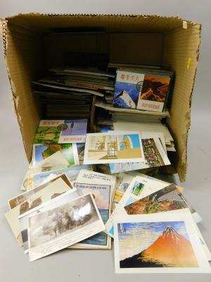 A large quantity of black and white and colour postcards