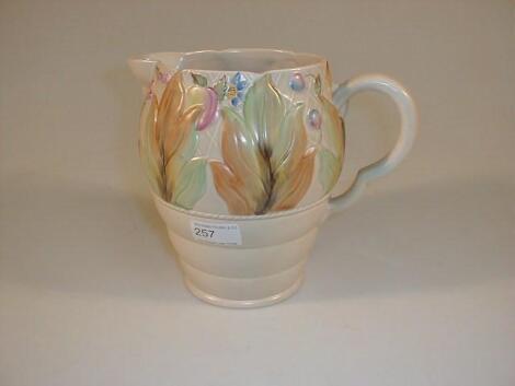 A Clarice Cliff jug with hand painted relief moulded floral and foliate decoration