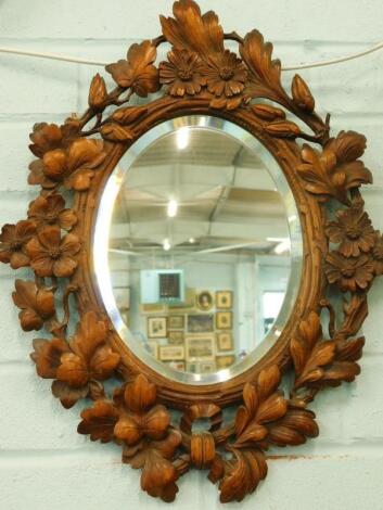 A Black Forest carved wall mirror