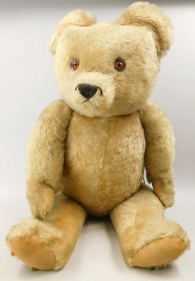 A large Tara gold plush teddy bear